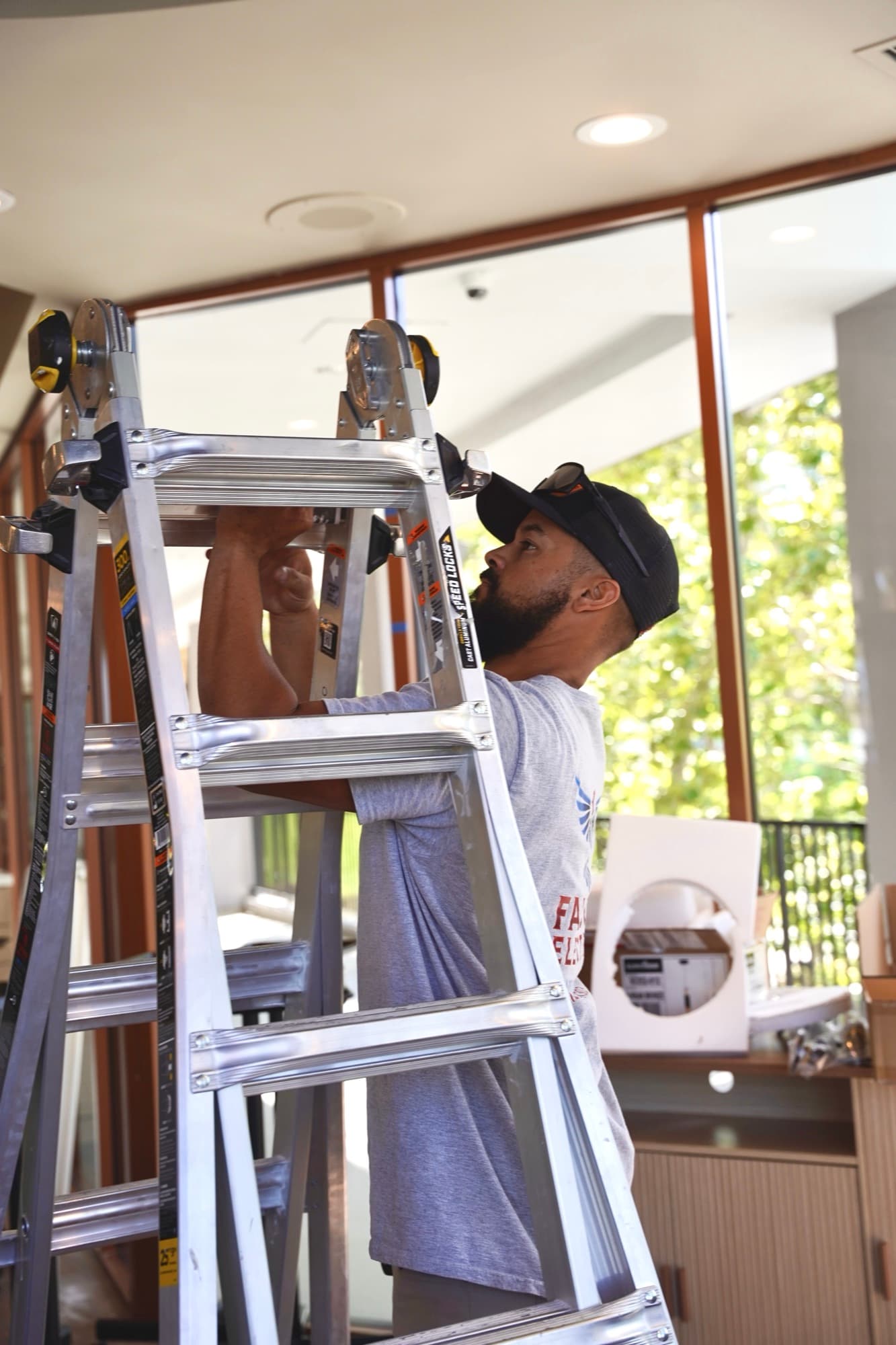 Ean Orchard installing a ceiling fixture