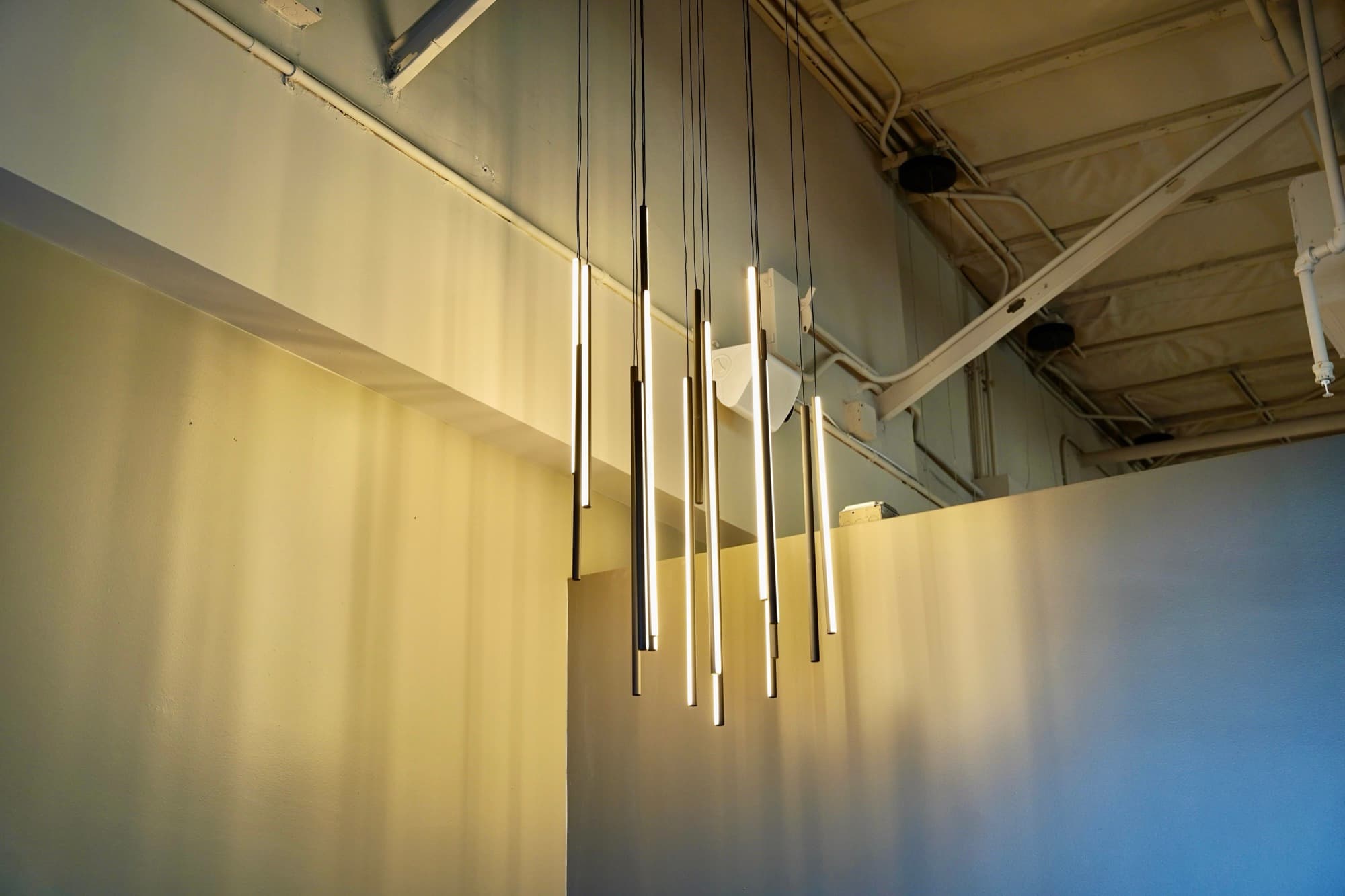 LED pendant lights lit up in a commercial install