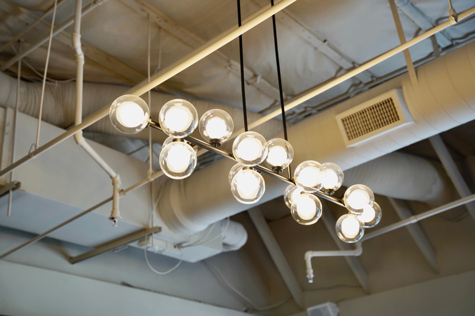 Custom modern chandelier installed in a commercial space, Falcon Electric
